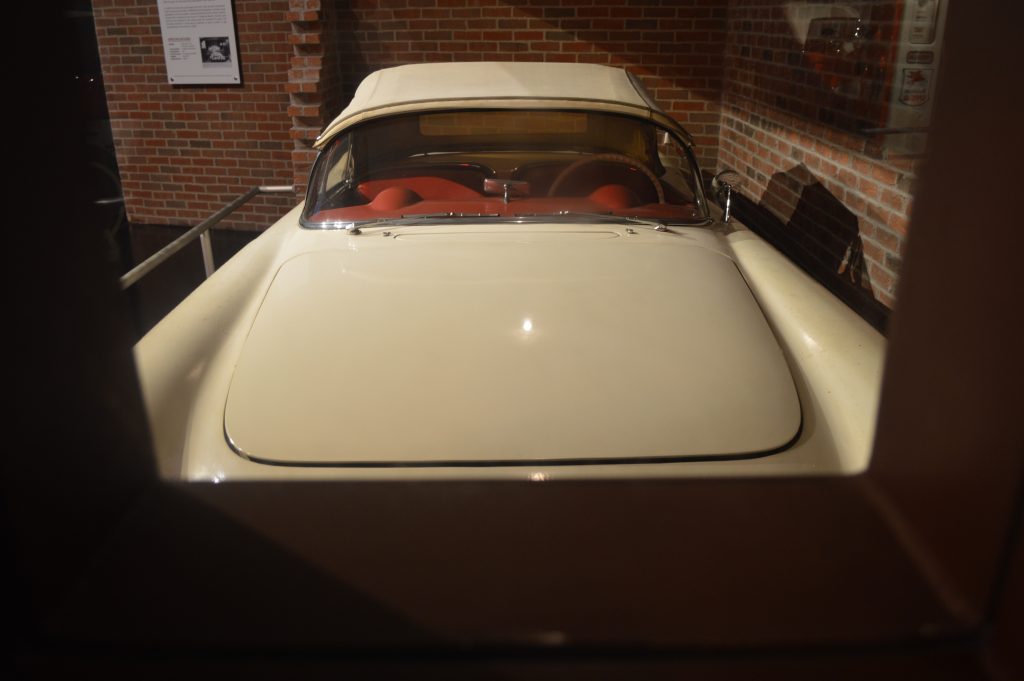 Richard Sampson's 1954 Corvette on display at the National Corvette Museum as seen thru the recreation of the original viewport built into the wall at Sampson's grocery store.